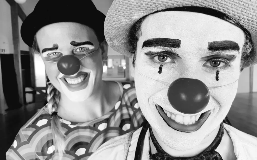 Two clowns smiling. The art of clowning